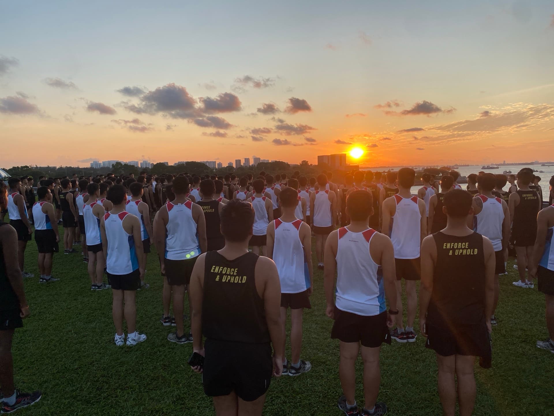 A military formation running at dawn, the discipline built long before pressure arrives