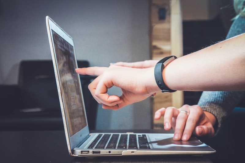 Hands pointing at a laptop screen while a claim is worked through together